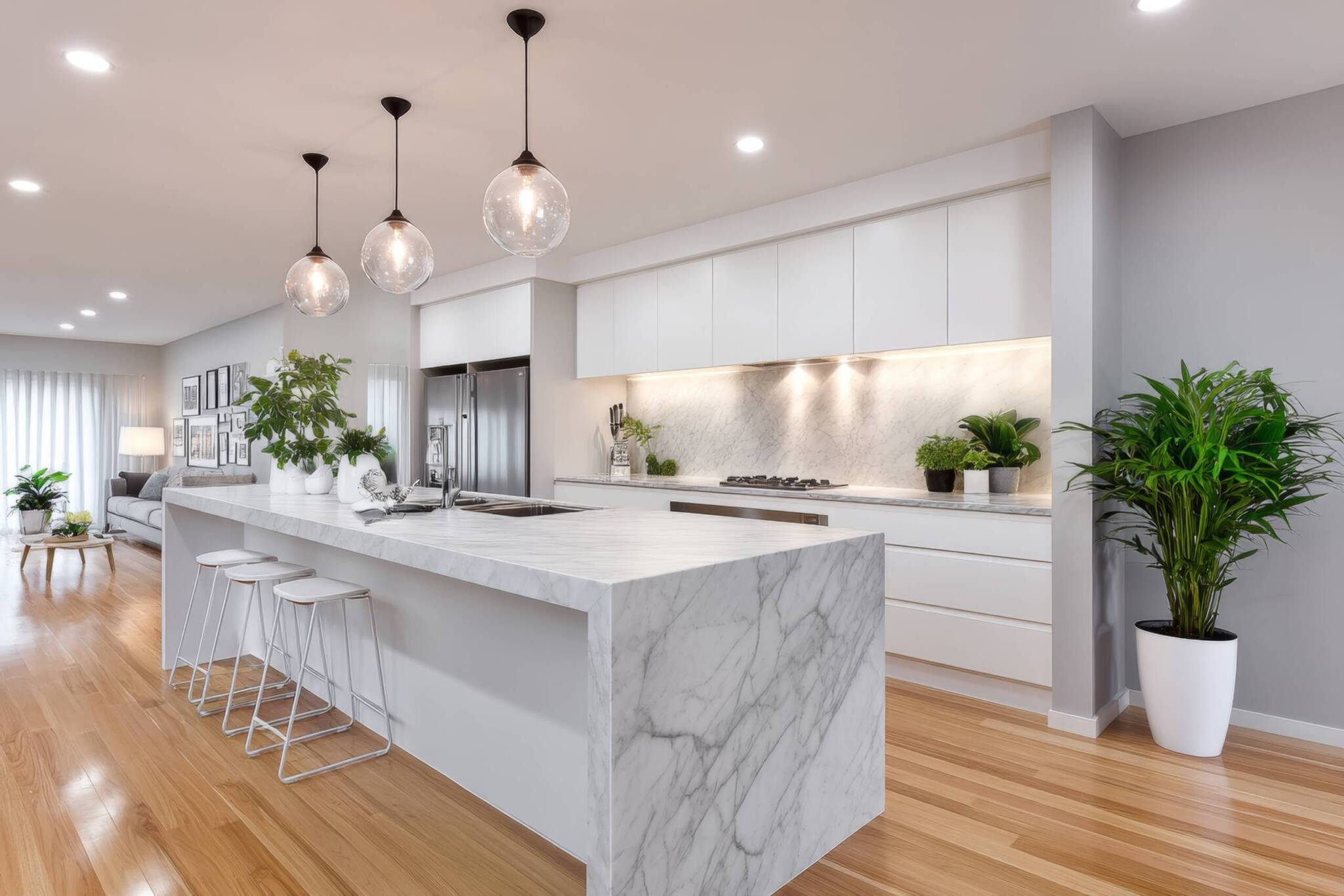 A bright kitchen with minimalist home decor, white marble countertops and indoor plants